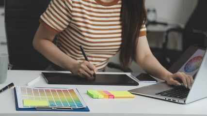 UX/UI designer working on wireframes for a website and mobile app prototype, surrounded by sketches of user-flow and design tools, in concept of website and mobile application design concept.