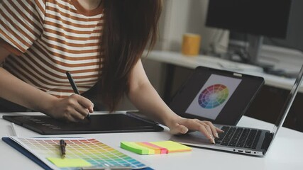 UX/UI designer working on wireframes for a website and mobile app prototype, surrounded by sketches of user-flow and design tools, in concept of website and mobile application design concept.