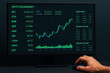 © NikonLamp - Candlestick cryptocurrency price chart with coin symbols, market prices, and trade history on a dark monitor screen