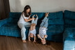 © Tina kids photo - Mom and daughters playing at home on the couch