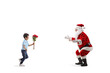 © Ljupco Smokovski - Full length profile shot of a boy giving flowers to Santa Claus