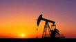 © Babb - A pump jack silhouette works against a stunning sunset in an oil field. The blending colors of the sky highlight the machinery, emphasizing energy extraction and production