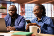 © DC Studio - African American freelancers at home collaborating on a research project, man using online reports and analytics via laptop. Young woman manages web correspondence on mobile phone.