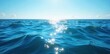 © Thida - Vast, deep blue ocean stretches to the horizon, undisturbed waves gently rolling under a clear sky  Sunlight dances on the surface, creating shimmering reflections , limitless, bright