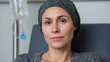 © Ilya - Woman with headscarf resting during chemotherapy session