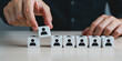 © Grid Byte Studio - Hand placing wooden cube with human icon showing talent selection human resources or hiring concept