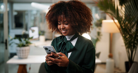 Aufkleber - Business woman, cellphone and designer typing in office for communication, overtime or fashion inspiration. Female person, tech and scroll for design feedback, social media and search at night