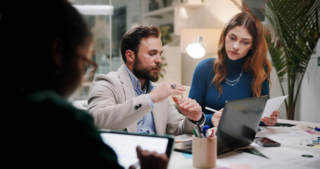 Poster - Business, teamwork or planning with laptop in office at night for marketing campaign, design feedback and strategy. Graphic designer, people and discussion for brand development, ideas and overtime