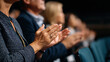 © INT888 - Audience clapping at formal event, showing appreciation and engagement, with diverse attendees in business or conference attire, seated in darkened auditorium or conference hall