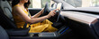 © Westend61 - Mature woman using digital tablet while driving electric car
