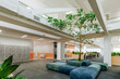 © Westend61 - Modern coworking office interior with plants and seating area