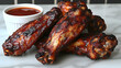 © Oktavia - Mouthwatering grilled chicken wings glazed with sweet barbecue sauce, served with dip