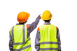 © Pituk - Back view of two engineers wearing yellow vests and helmet discussing project standing isolated on white background.