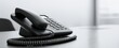 © MP Studio - The black telephone on a sleek office desk with a minimalist design.