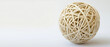 © Vitor - Uma bola texturizada intrincadamente tecida em um fundo branco limpo com imagem de espaço generoso para texto