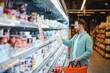 © Serhii - Man shopping for groceries in supermarket aisle