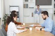 © New Africa - Colleagues eating and chatting during lunch break in office