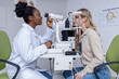 © zinkevych - Young woman having a vision exam at the optometrist