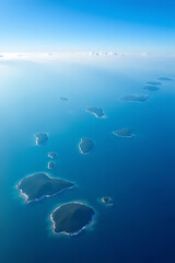 Wall Mural - Aerial view of the Indian Ocean with diverse islands and cloud formations, high clarity and vibrant tones