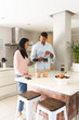© Wavebreak Media - Couple enjoying morning coffee together in modern kitchen, sharing conversation
