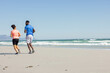 © Wavebreak Media - Couple jogging on beach, enjoying sunny day and ocean view together