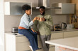 © Wavebreak Media - Couple enjoying coffee together in modern kitchen, smiling and relaxing