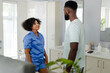 © Wavebreak Media - Couple in bathroom having conversation, woman in pajamas smiling at partner