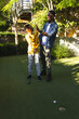 © Wavebreak Media - Celebrating successful putt on backyard putting green, father and son bonding