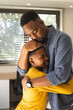 © Wavebreak Media - African American father hugging child at home, both showing love and affection