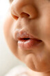 © Erika - Macro Close-Up of Baby’s Lips and Nose in Warm Natural Light Highlighting Texture and Innocence