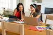 © Wavebreak Media - Studying Diverse female friends collaborating in bright living room, consulting laptop and swatches