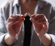 © New Africa - Woman holding broken cigarette, closeup. Stop smoking