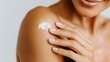 © Newleks - Close up of woman applying moisturizing cream on shoulder, highlighting gentle skincare routine for soft, radiant skin