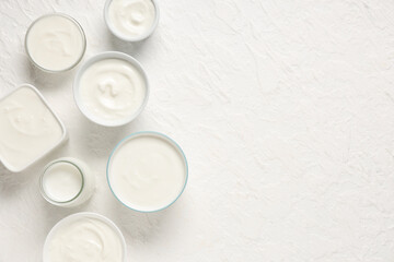 Wall Mural - Bowls of tasty yogurt on white background