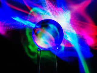 Wall Mural - a clear glass ball is sitting on a pedestal. colorful background. abstract graphic background. light