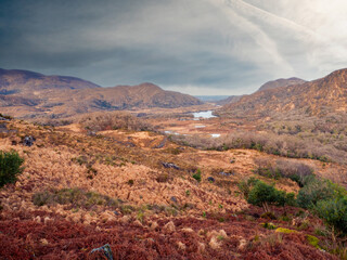 Wall Mural - Stunning nature scene with lake in a valley, mountains and blue dramatic cloudy sky. Killarney area of Ireland. Travel and tourism. Irish nature landscape scene. Nobody.