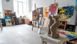 © SolaruS - Artists studio showcasing a clay sculpture, vivid abstract paintings, and natural light. Ideal for concepts relating to creativity, passion, and the arts.