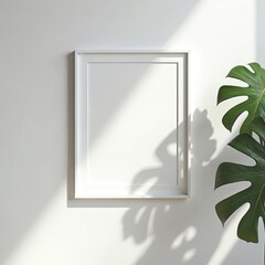 Poster - Blank frame mockup on white wall. Shadow of plant leaf creates design. Interior decor for art. Modern empty template for picture, poster. Gallery wall, interior design concept.