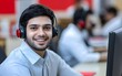 © Saimon - Smiling Customer Service Agent Wearing Headset in Office