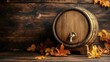 © dira - Rustic oak barrel with brass tap amidst autumnal foliage on a wooden surface