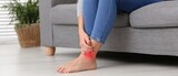 Person experiencing ankle pain highlighted in red.