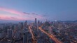 © K4VEE - Panoramic city skyline at dusk featuring modern skyscrapers against blue evening sky. Urban landscape captures twilight atmosphere with bustling streets below