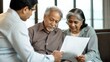 © Jo - Indian Elderly Couple Reviewing Financial Documents with Consultant