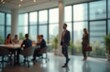© Pete - Blurred modern office interior. Business people meeting, working. Large panoramic windows, bright lighting. Corporate workplace design. Empty business hall for company. Teamwork concept.