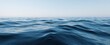 © MP Studio - The serene blue ocean waves under a clear sky at dawn.