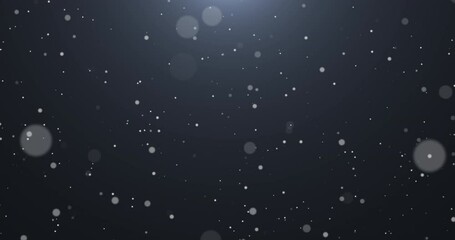 Wall Mural - Slowly falling, swirling, and sparkling bokeh particles in white light against a dark background. Abstract snow.