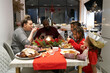 © Christina - Parents and children at Christmas dinner at home