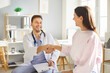 © Studio Romantic - Smiling and positive male doctor or nurse shakes hands with a patient during a medical appointment in a hospital or clinic. Healthcare, care, and trust in professional consultation.