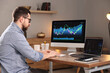 © New Africa - Stock exchange. Man analysing financial market on computer at desk indoors