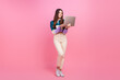 © deagreez - Young woman with laptop on pink background embodying cheerful and trendy fashion essence